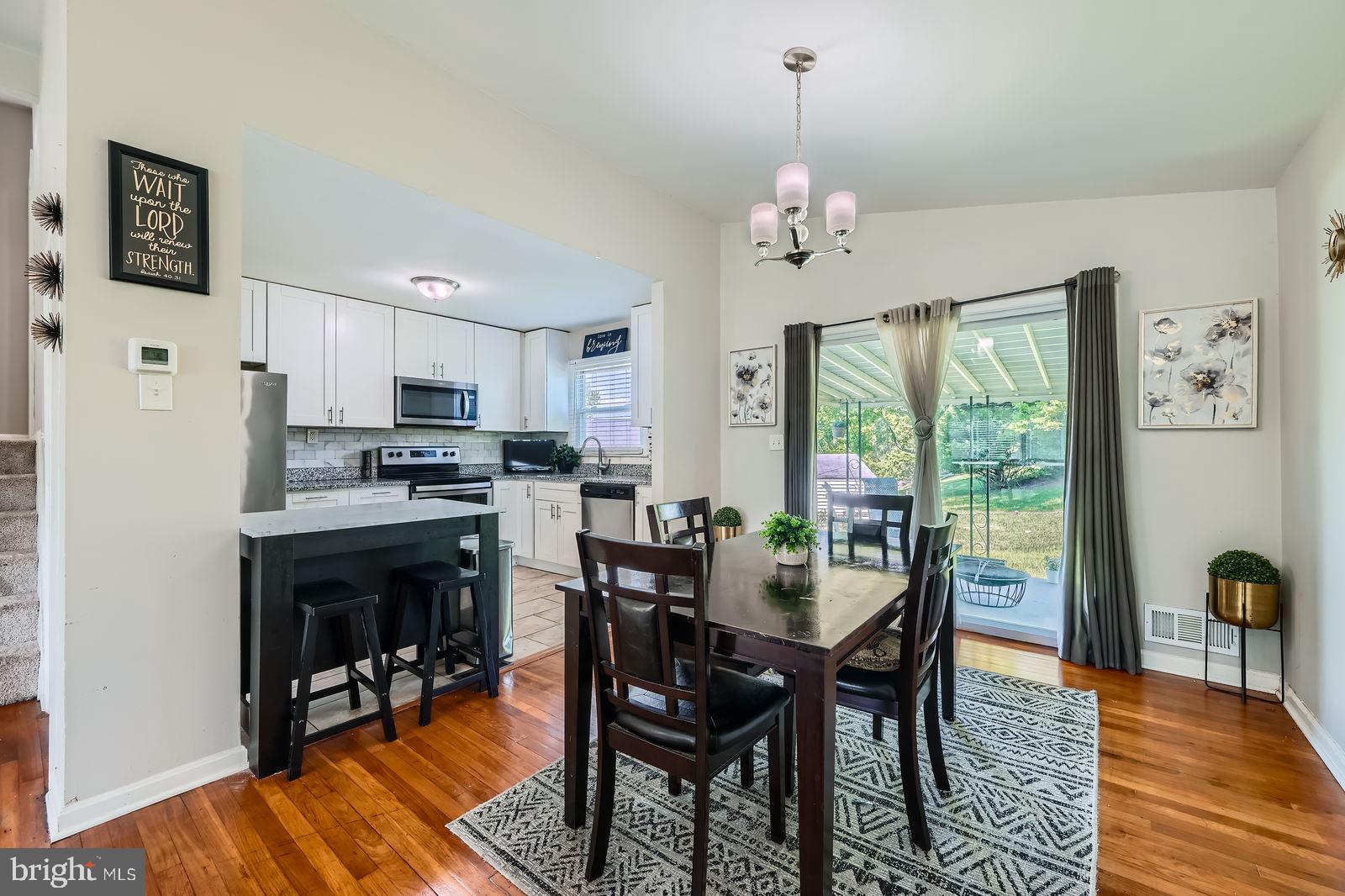 1201 Cobb Road Baltimore, MD 21208 - Photo 7 of 28 a dining room with furniture a chandelier and wooden floor