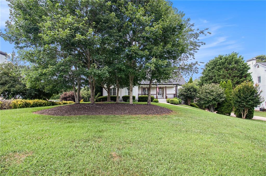 4835 Sewell Road Cumming, GA 30028 - Photo 1 of 1 a view of a house with a yard and basketball ground