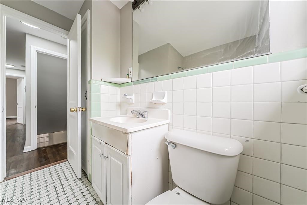 3837 Mayfield Road Cleveland, OH 44121 - Photo 21 of 29 Bathroom with vanity, tile walls, and light tile patterned floors