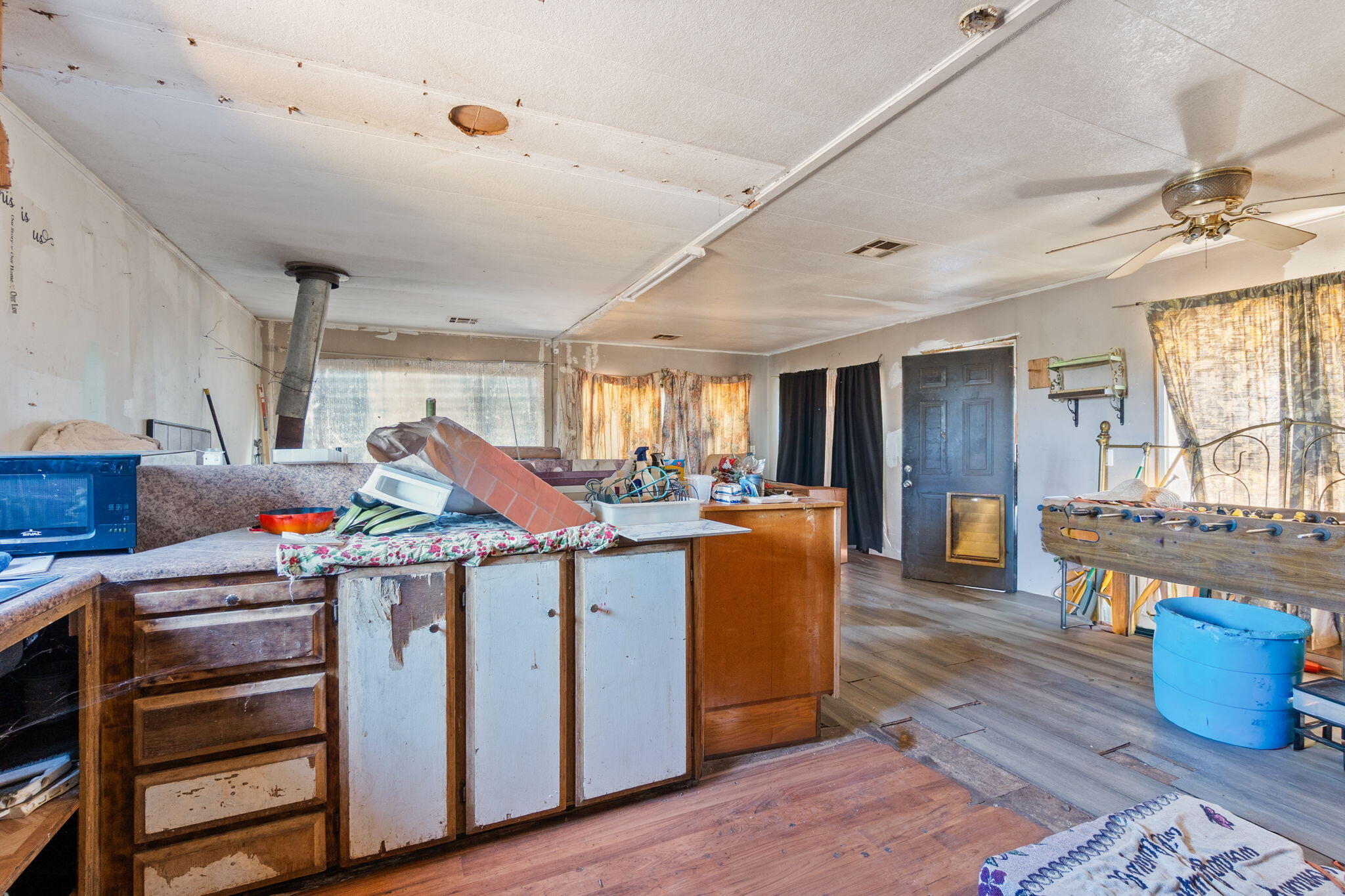 13957 Gas Point Road Igo, CA 96047 - Photo 5 of 18 a utility room with stainless steel appliances granite countertop a stove cabinets and wooden floor