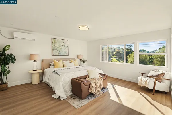 a spacious bedroom with a bed and a couch