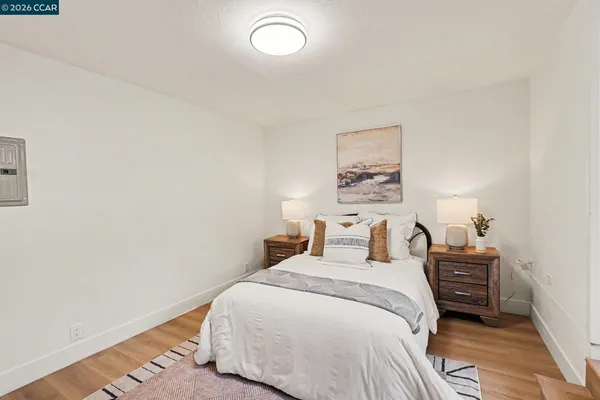 a bedroom with a bed and a lamp