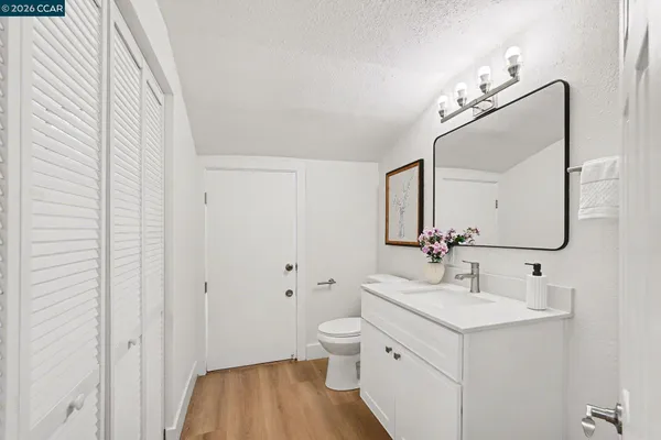 a bathroom with a sink a toilet and a mirror