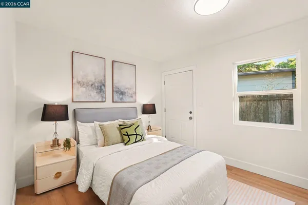 a bedroom with a bed and a night stand