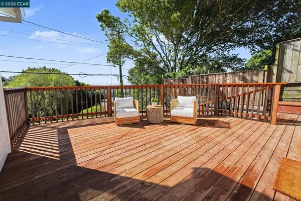 a view of a deck with furniture and wooden floor