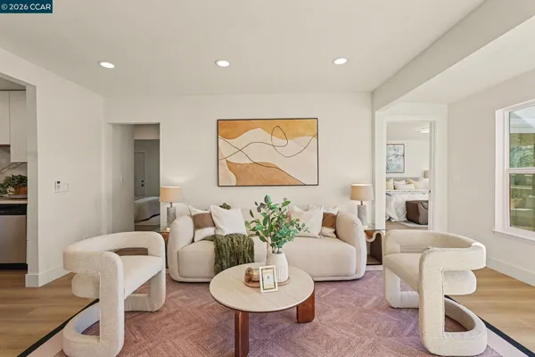 a living room with furniture potted plant and a window