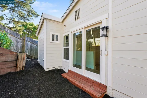 a view of a small house with backyard