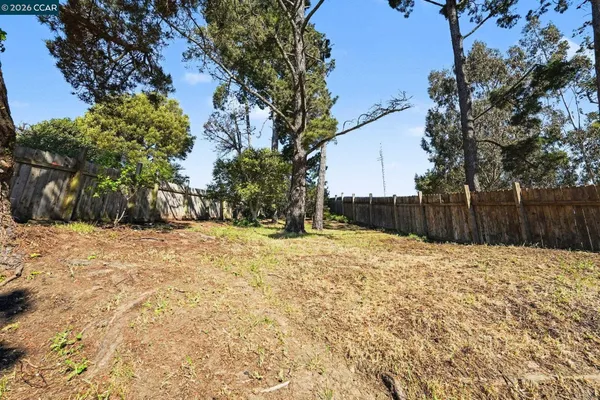 a view of wooden fence and trees