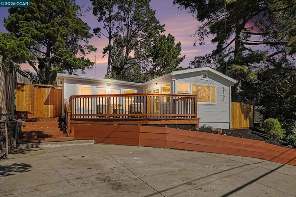 a view of backyard with deck and seating area