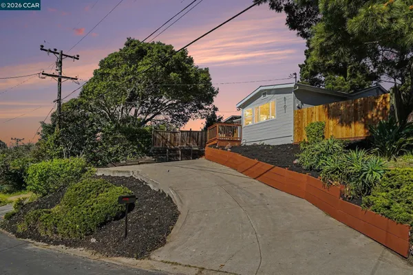 a front view of a house with a yard and a garage