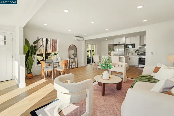 a living room with fireplace furniture and a dining table