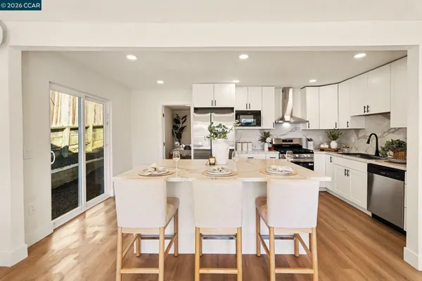 a kitchen with kitchen island wooden cabinets and white appliances