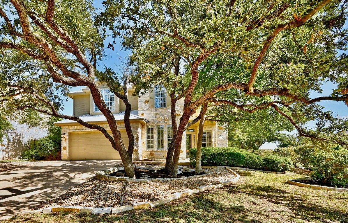 a view of a house with a tree tree front of it