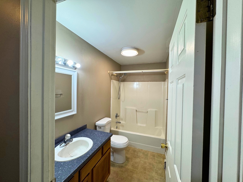 3 Davids Way, Unit A Wareham, MA 02576 - Photo 12 of 18 a bathroom with a granite countertop sink toilet a mirror and shower