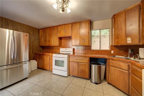 a kitchen with cabinets appliances and a window