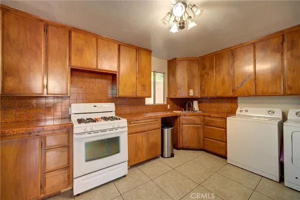 a kitchen with a stove top oven sink and cabinets