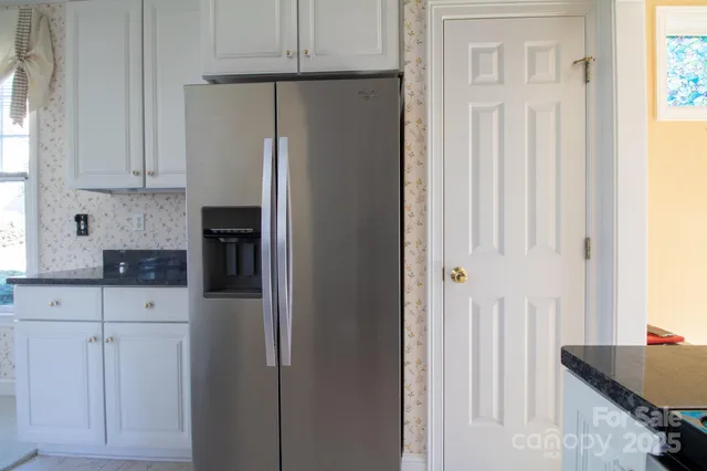 a view of an empty room and a ceiling fan