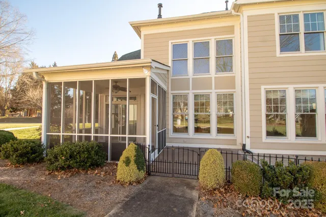 a view of a blue house with many windows and yard