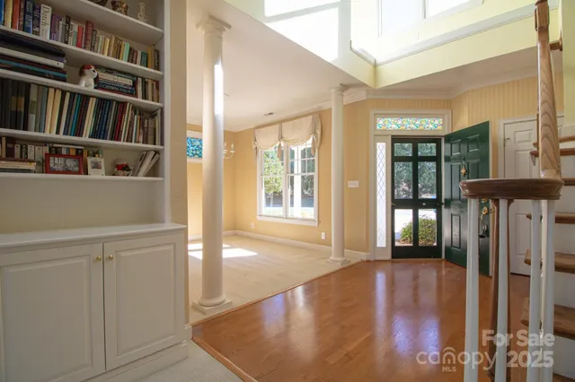 an empty room with windows and fireplace