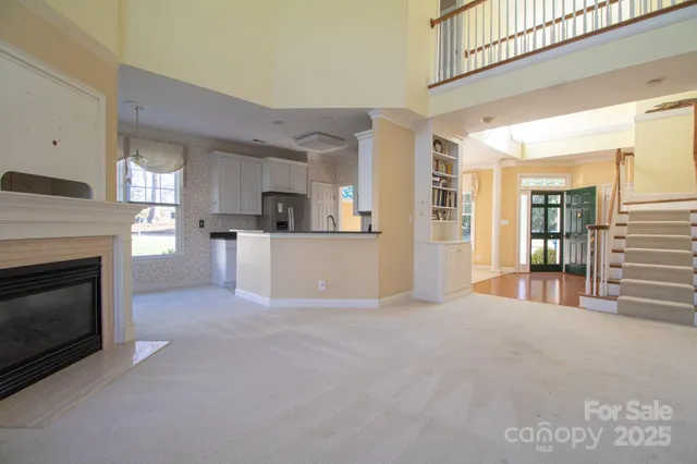 a view of a livingroom with a fireplace and window