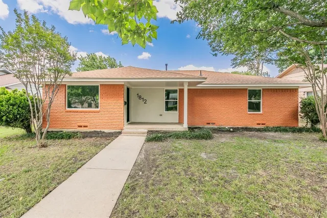 a backyard of a house with plants and garden