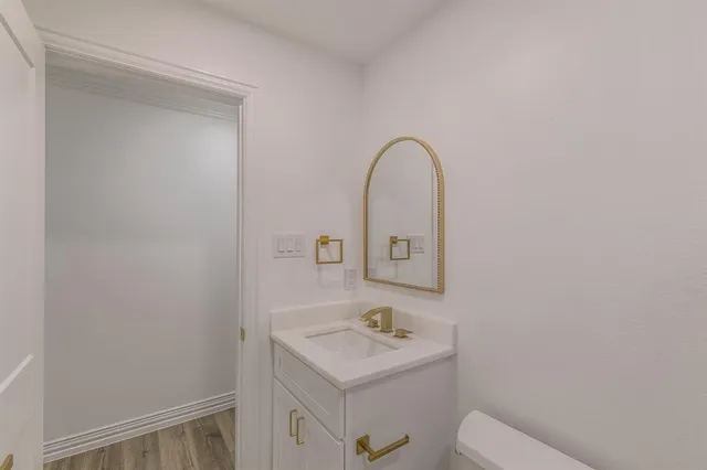 a bathroom with a sink a toilet and a mirror