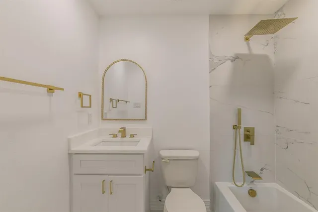 a bathroom with a sink toilet and shower