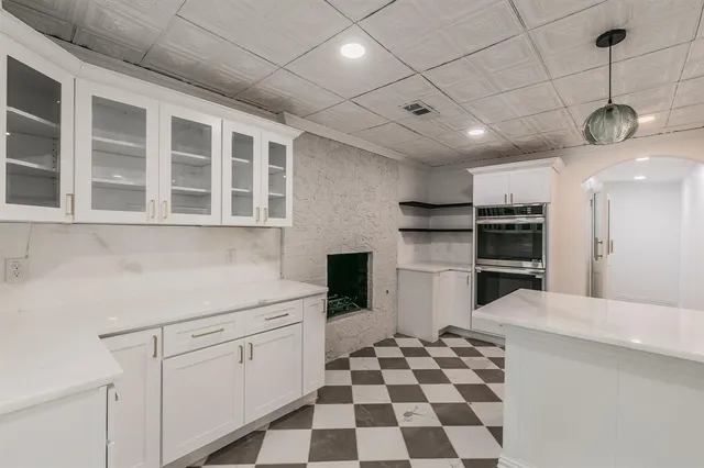 a kitchen with a stove a sink and a refrigerator