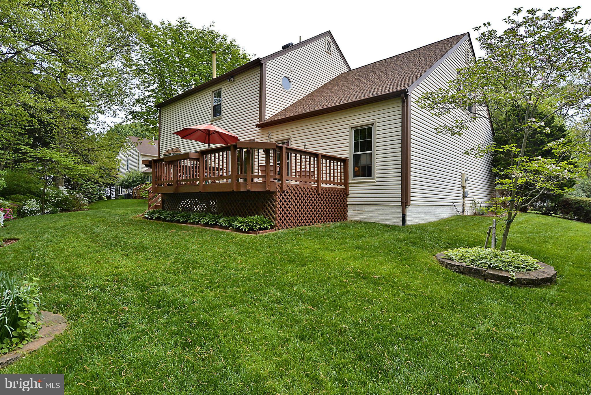 9213 Wyeth Lane Burke, VA 22015 - Photo 23 of 28 a front view of a house with a garden and yard