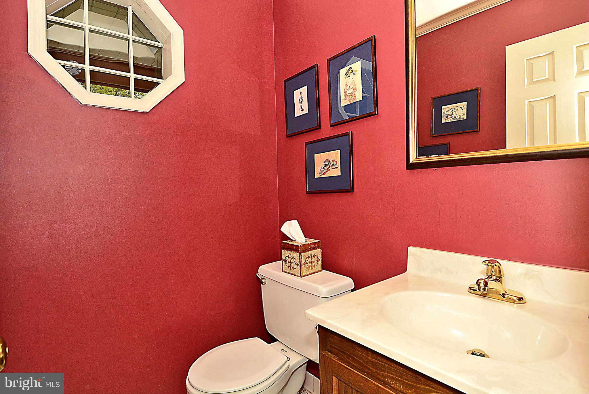 9213 Wyeth Lane Burke, VA 22015 - Photo 4 of 28 a bathroom with a sink mirror and toilet