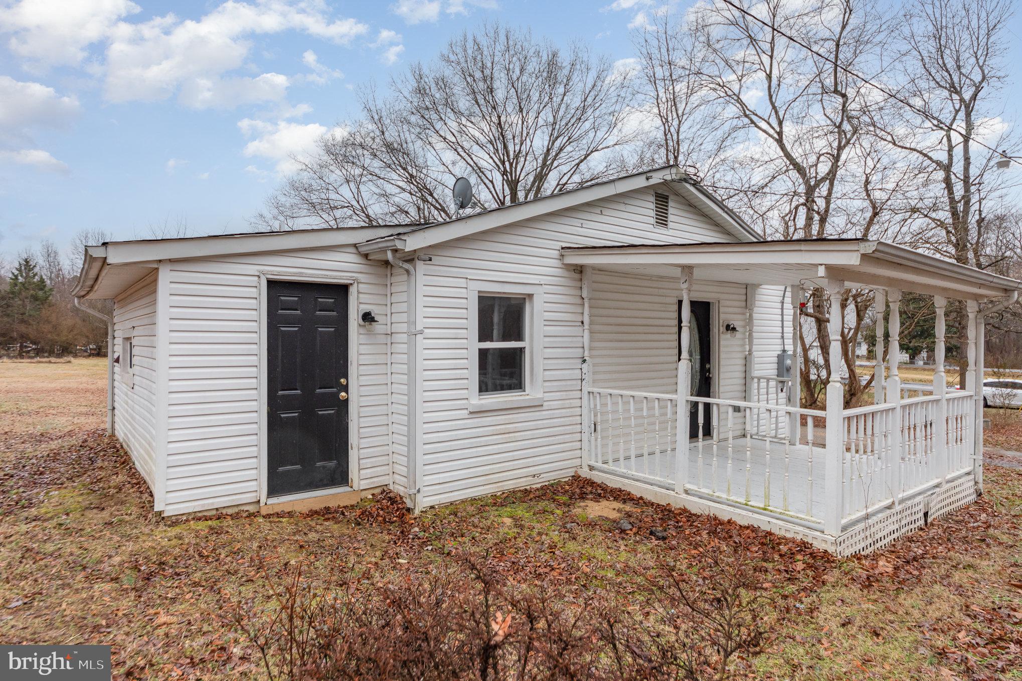 9003 Smiths Bend Road Fredericksburg, VA 22407 - Photo 1 of 22 a view of a house with a yard and garage