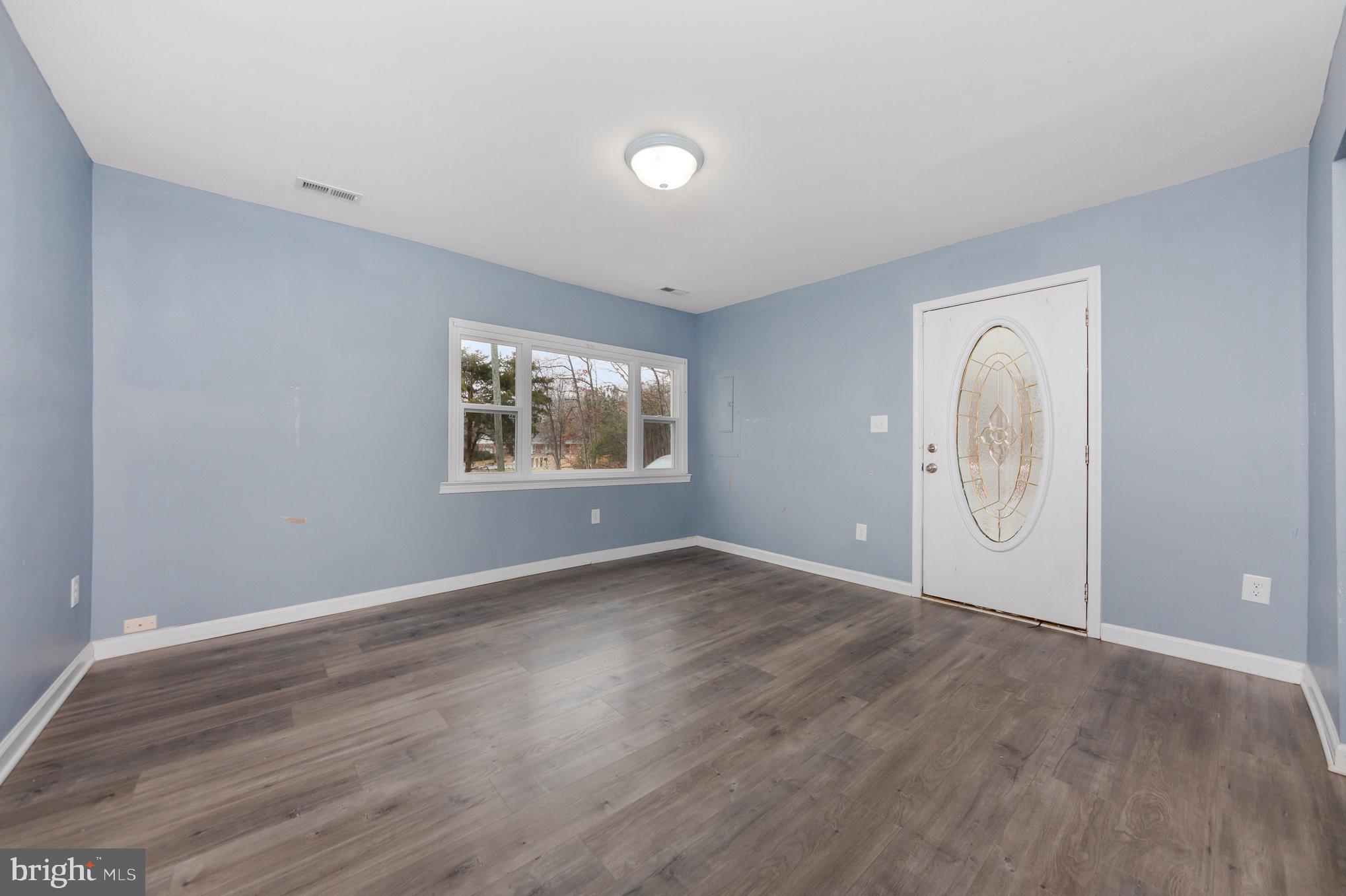 9003 Smiths Bend Road Fredericksburg, VA 22407 - Photo 5 of 22 an empty room with wooden floor and windows