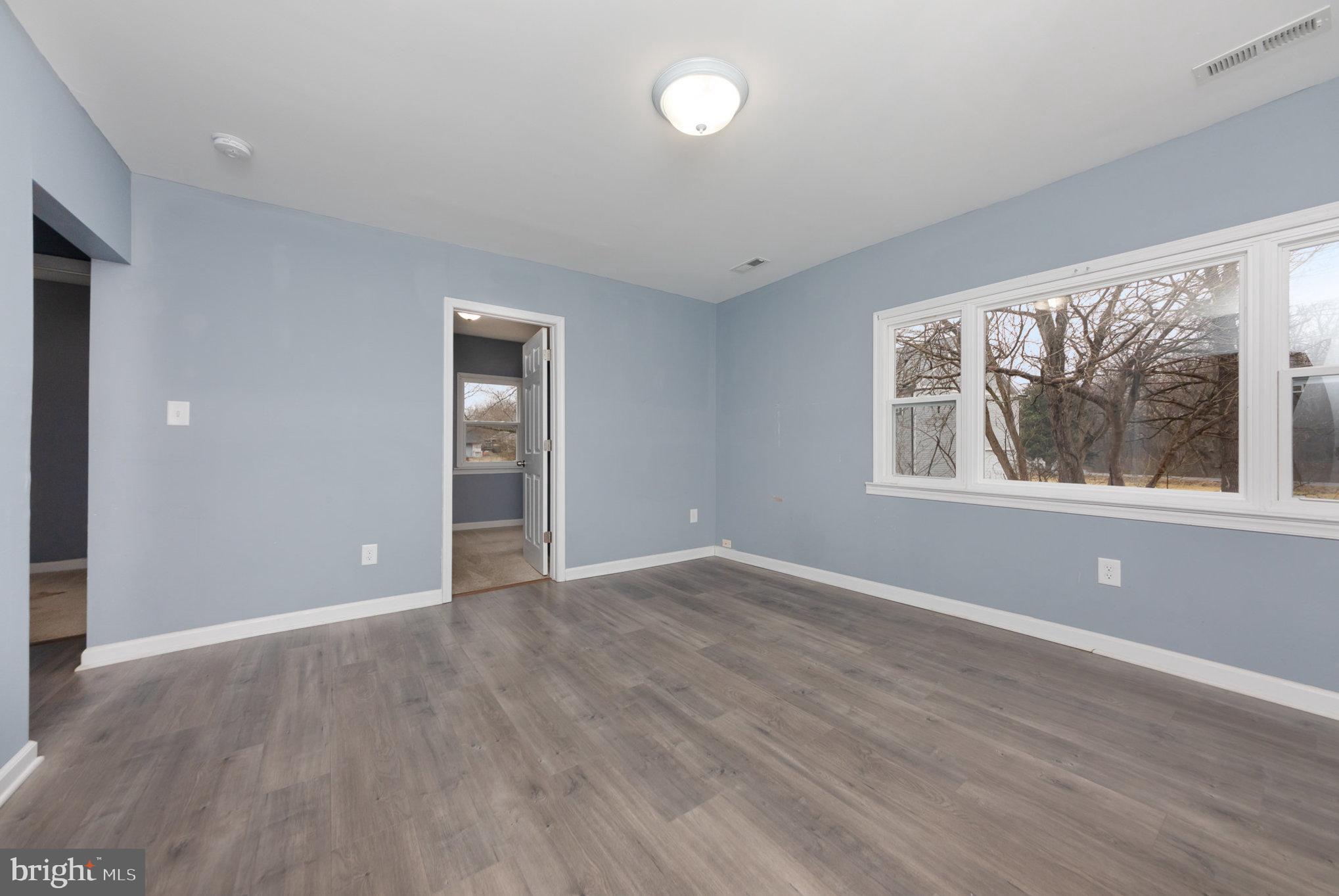 9003 Smiths Bend Road Fredericksburg, VA 22407 - Photo 10 of 22 a view of an empty room with wooden floor and a window