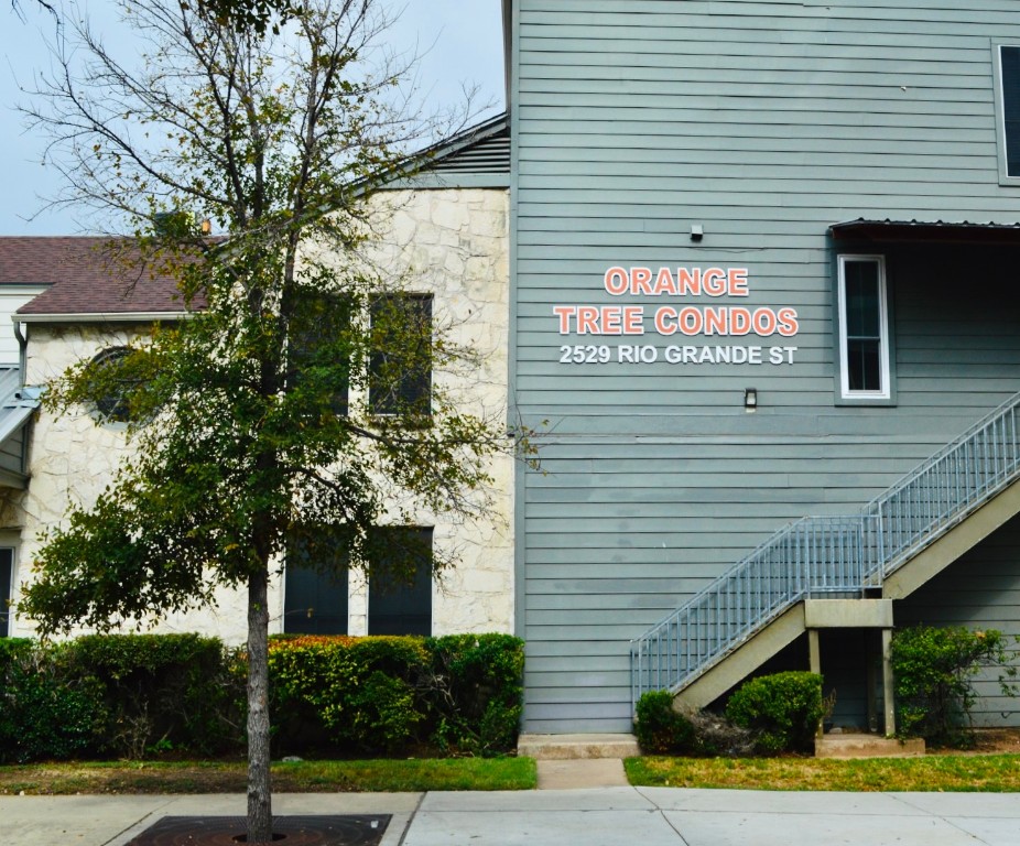 2529 Rio Grande Street, Unit 13 Austin, TX 78705 - Photo 2 of 10 a sign that is on the side of a brick building