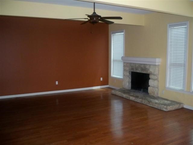 2529 Rio Grande Street, Unit 13 Austin, TX 78705 - Photo 8 of 10 a view of empty room with wooden floor and fireplace