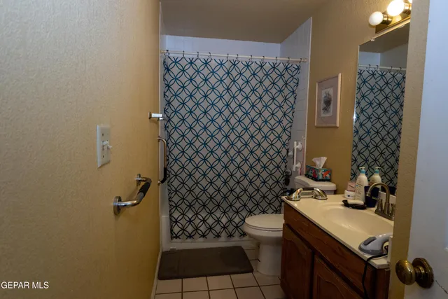 a bedroom with a bed a large window and chair