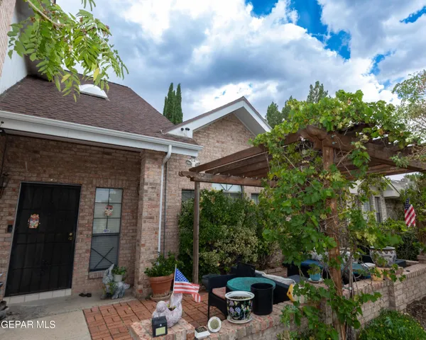 a view of a patio with table and chairs and potted plants