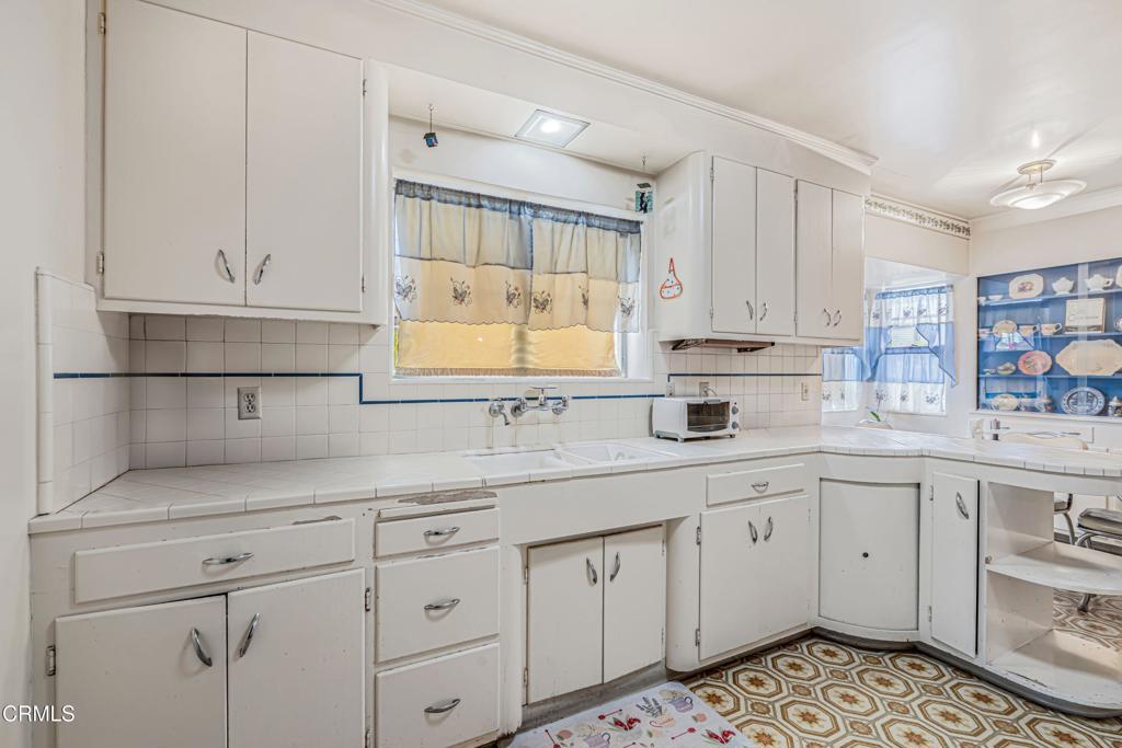336 Doris Avenue Oxnard, CA 93030 - Photo 16 of 44 a kitchen with white cabinets and sink