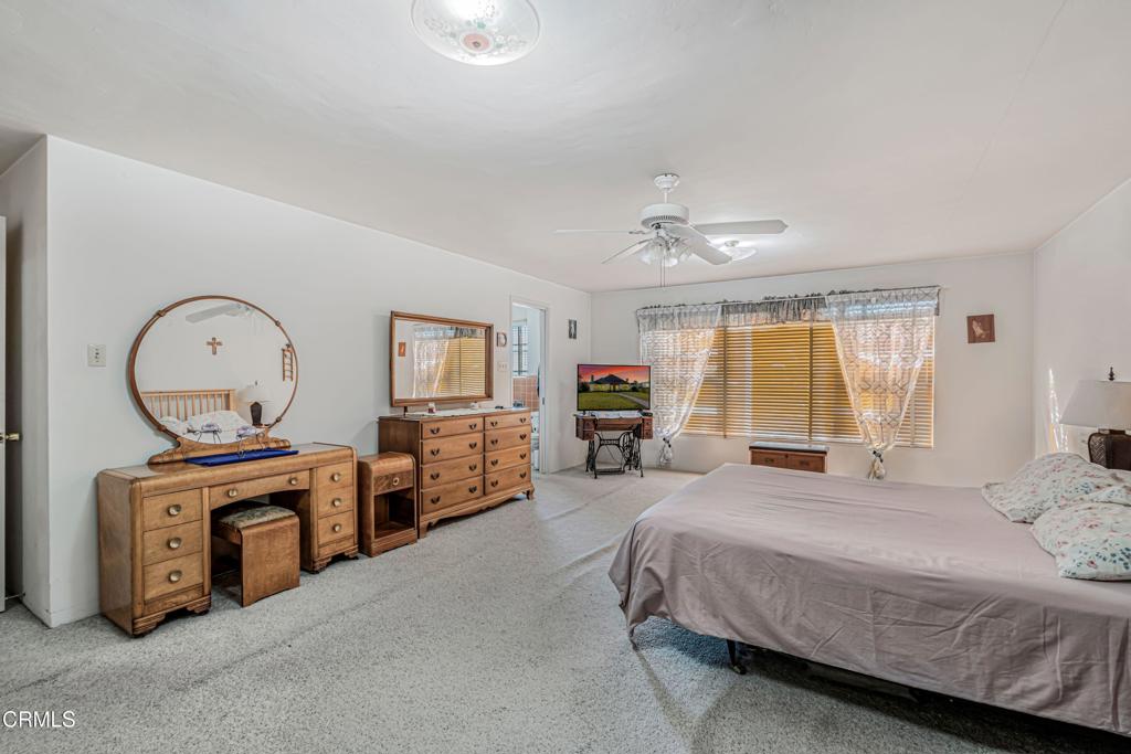 336 Doris Avenue Oxnard, CA 93030 - Photo 21 of 44 a bedroom with furniture and a chandelier