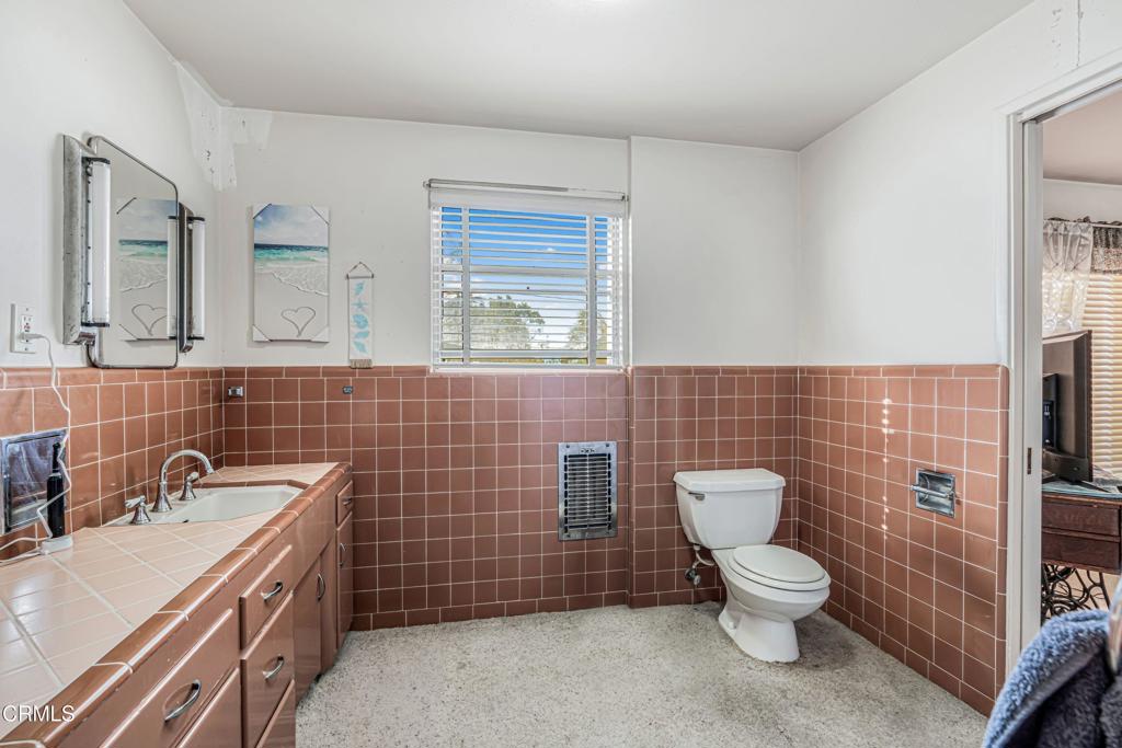 336 Doris Avenue Oxnard, CA 93030 - Photo 24 of 44 a bathroom with a toilet a sink and mirror