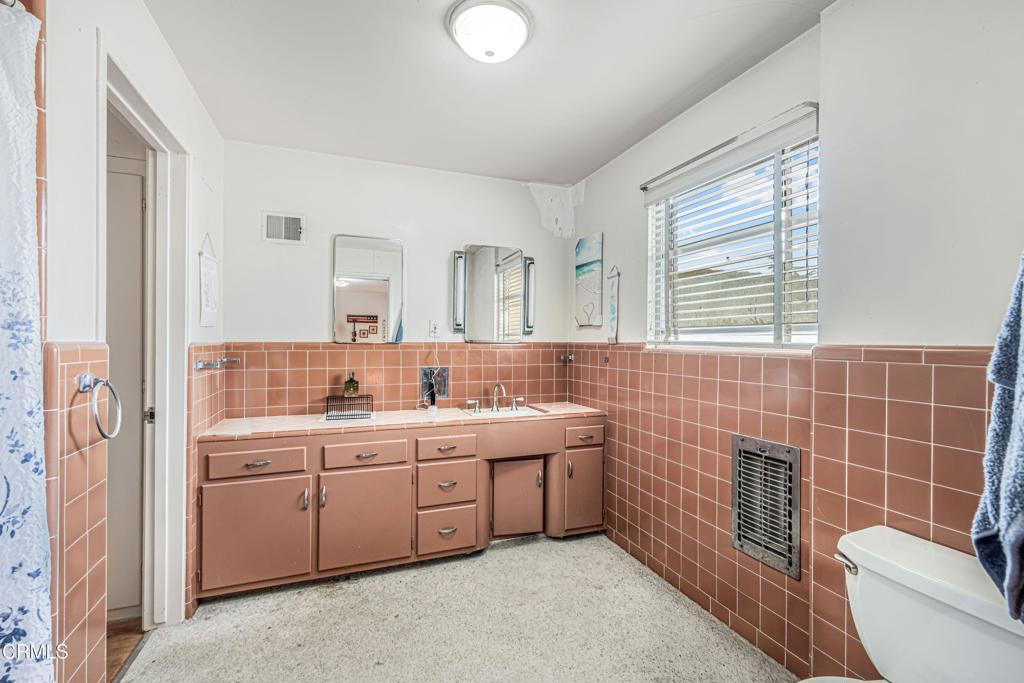 336 Doris Avenue Oxnard, CA 93030 - Photo 25 of 44 a bathroom with a double vanity sink a toilet and a mirror