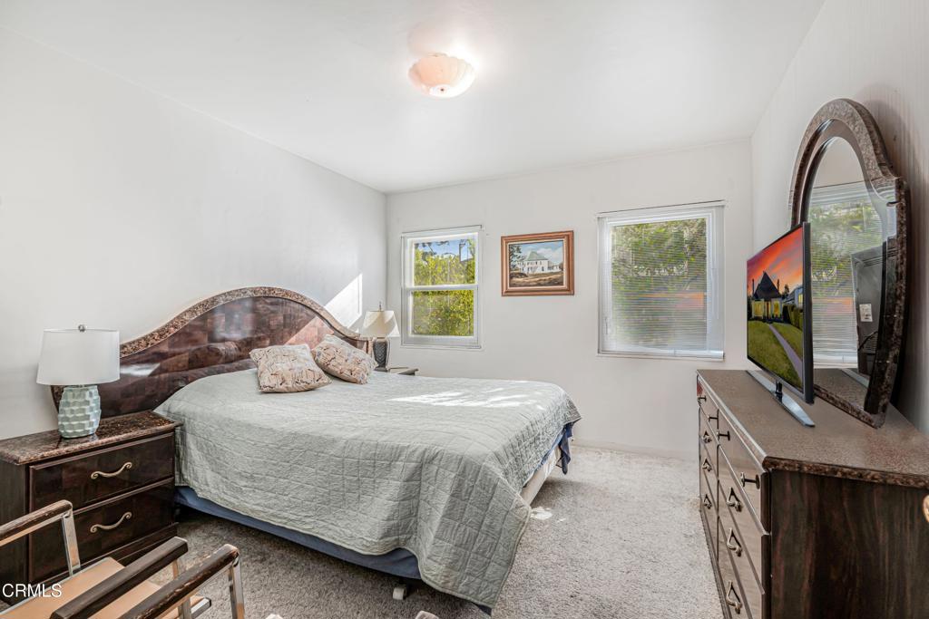 336 Doris Avenue Oxnard, CA 93030 - Photo 26 of 44 a bedroom with a bed and a flat tv screen on dresser