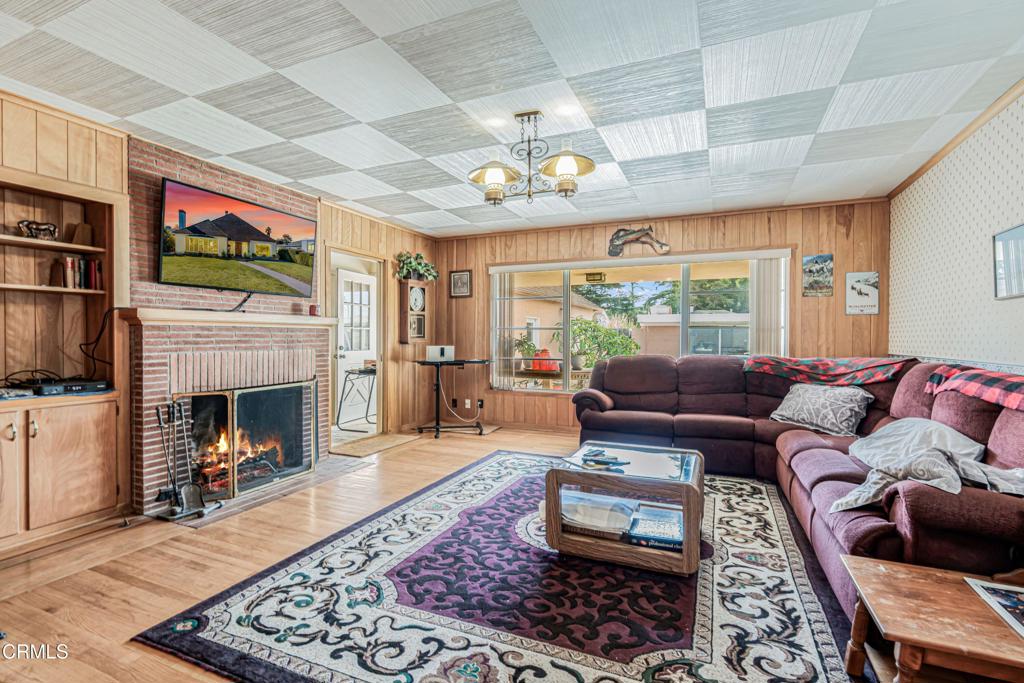 336 Doris Avenue Oxnard, CA 93030 - Photo 9 of 44 a living room with furniture a flat screen tv and a fireplace