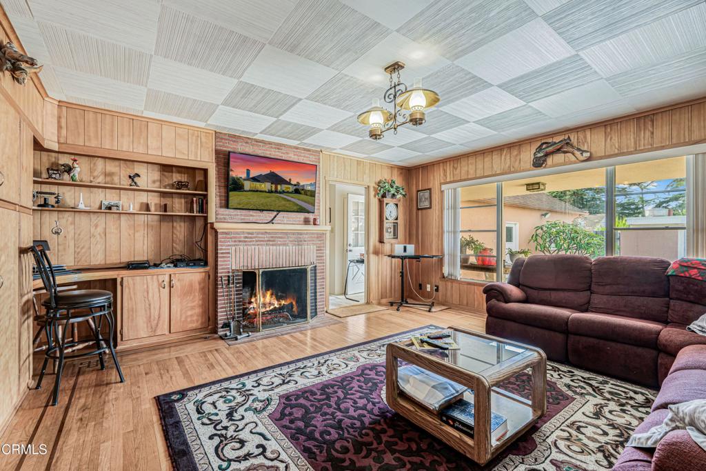 336 Doris Avenue Oxnard, CA 93030 - Photo 10 of 44 a living room with furniture a fireplace and a flat screen tv