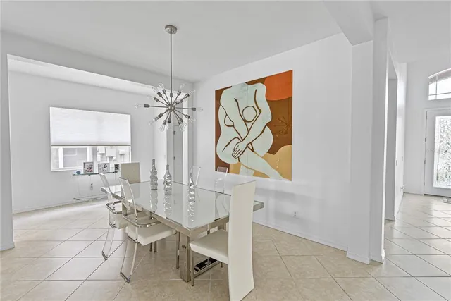 a living room with a table and chairs