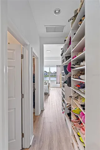 a view of walk in closet with clothes