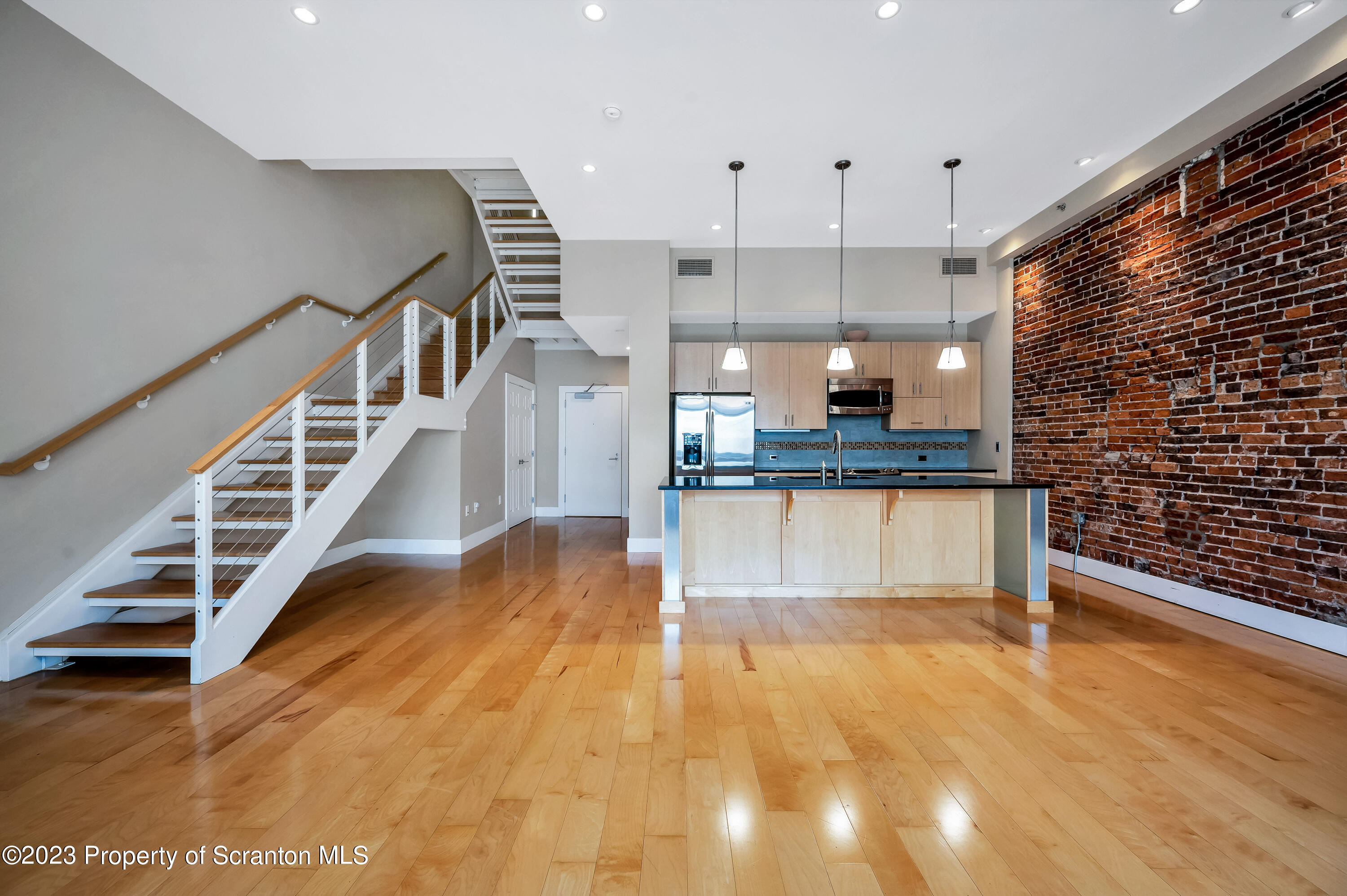 a view of kitchen and hall with wooden floor