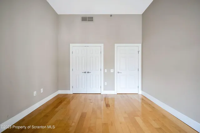 a view of a room with wooden floor