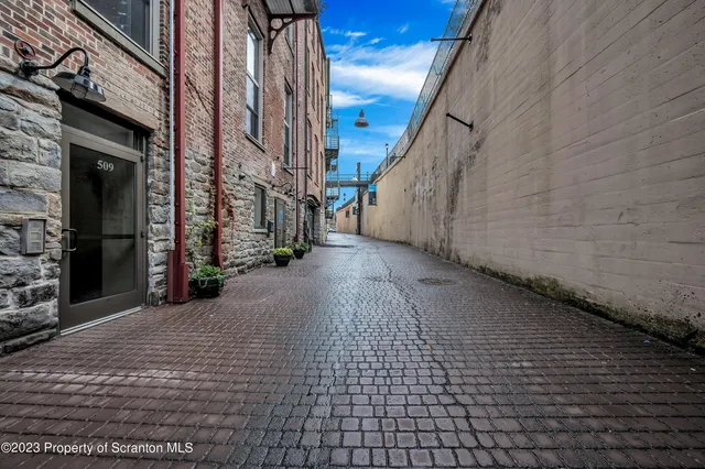 a view of a street with brick wall