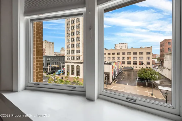 a large kitchen with kitchen island granite countertop a stove a sink and a refrigerator